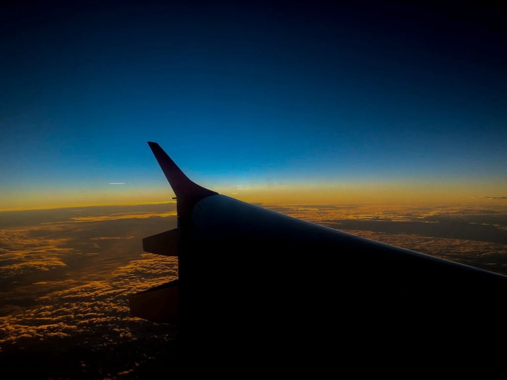 Airplane preparing for departure at sunset
